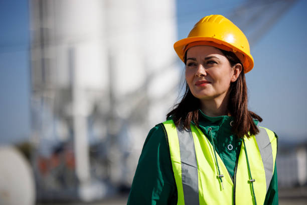 Portrait of female engineer with hardhat at factory industry workplace stock photo