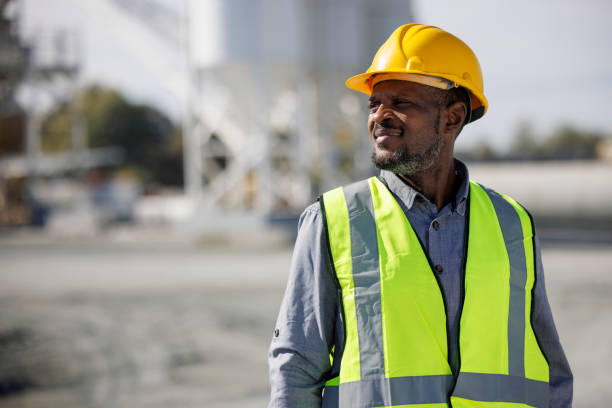 istock Portrait of smiling engineer with hardhat at construction site 1444189744