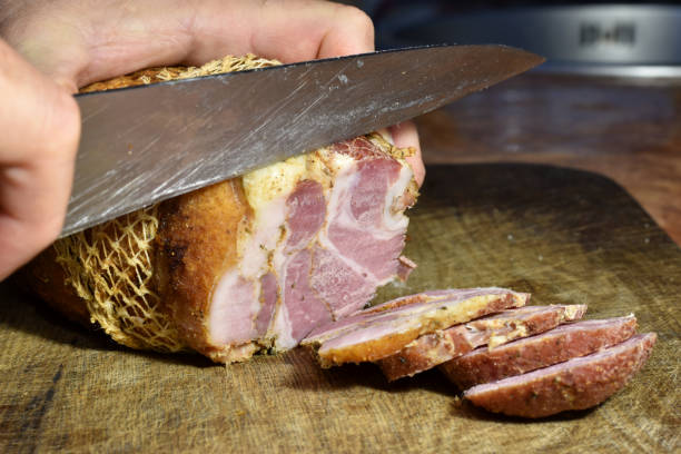 istock A piece of boiled pork is cut with a knife. 1444191653