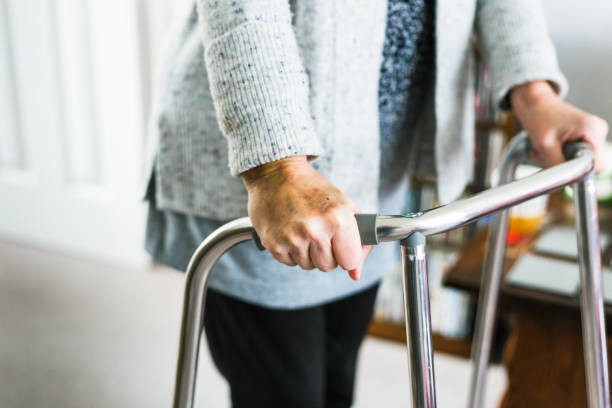 istock Senior woman using walker at home 1444192427