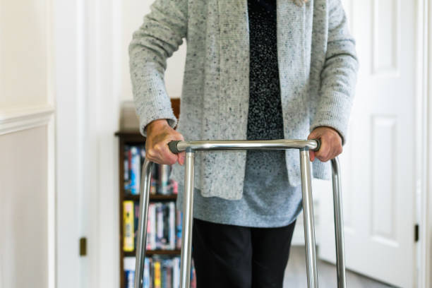 istock Senior woman using walker at home 1444192473