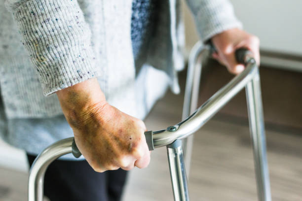 istock Senior woman using walker at home 1444192544