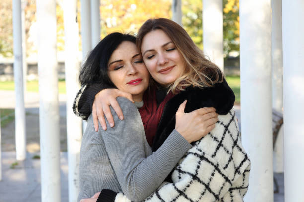 istock two women in autumn outside and hugging 1444196928