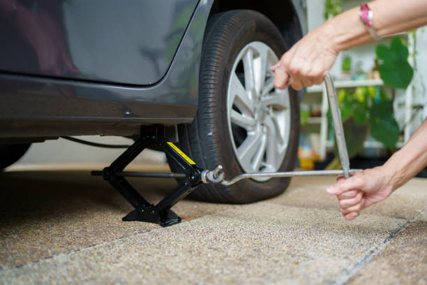 istock Woman changing flat vehicle tyre. 1444196982