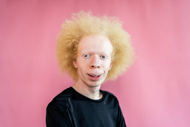 istock Portrait of a young man on a pink background 1444197603