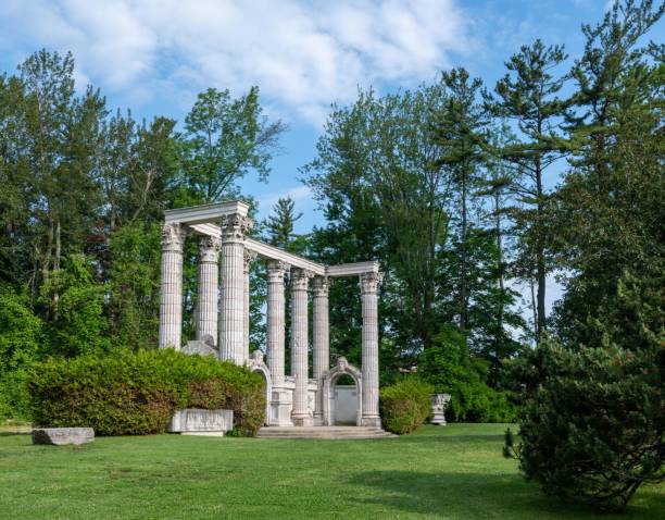 istock Old columns in the park surrounded with trees 1444200249