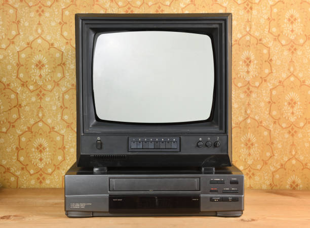 istock Old black vintage TV and VCR on wallpaper background. 1444201193