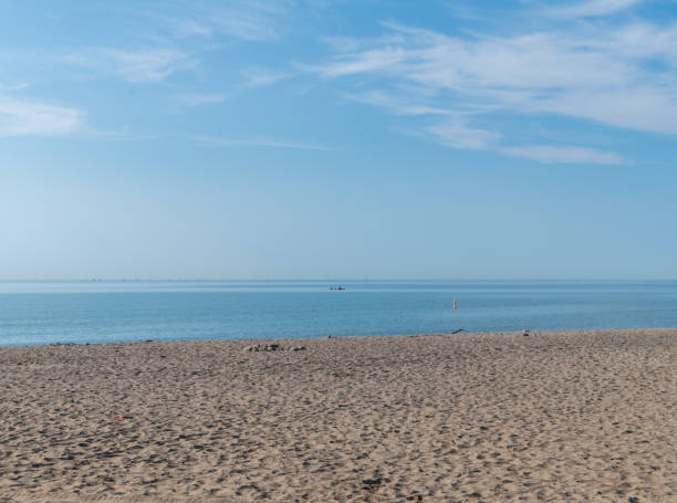 istock Sandy beach at Lake Ontario with blue sky 1444201289