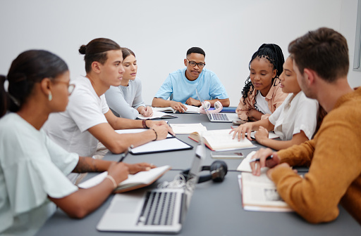 Diversity, education or university students in classroom learning, collaboration or working on maths or physics research. Books, laptop and notebook for college group project search for scholarship