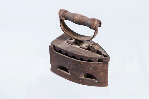A close up of an antique iron. Isolated background