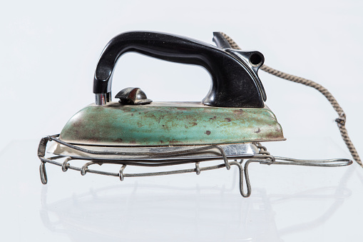 A close up of an antique iron. Isolated background