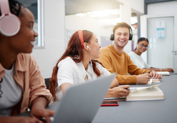 istock Music, studying and students learning at a university with notebook and technology in a classroom. Friends with smile for education and audio on headphones while doing a group project at college 1444206019