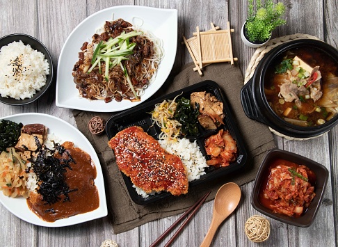 Assorted food of Curry Pork Chop Rice, Kimchi, Korean Jajangmyeon, Beef miso soup, Chicken Chop Bento, served dish isolated on table top view of asian food