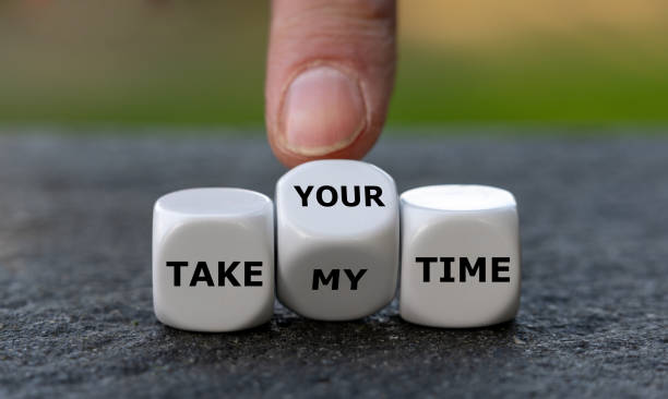 istock Hand turns dice and changes the expression 'take my time' to 'take your time'. 1444206280
