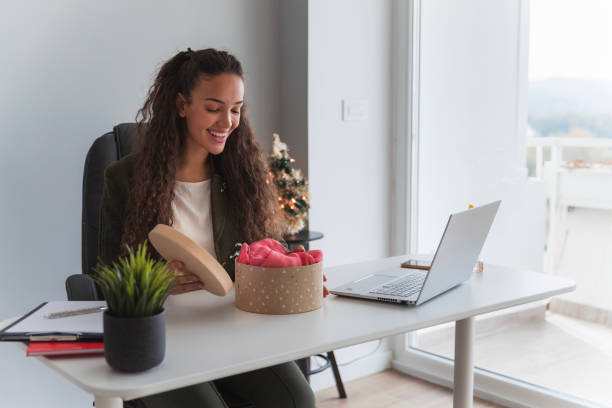 istock Happy woman opening gift box in office 1444207748