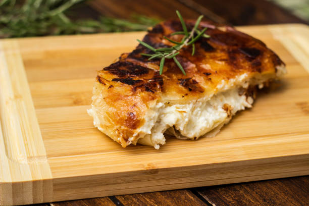 istock Homemade cheese pie, one piece on cutting board 1444208705
