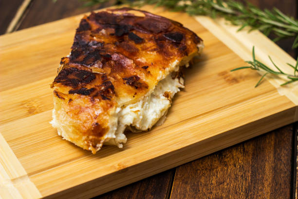 istock Homemade cheese pie, one piece on cutting board 1444208716
