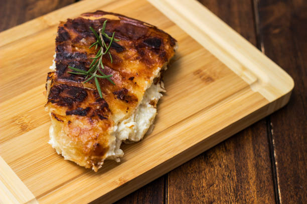 istock Homemade cheese pie, one piece on cutting board 1444208720