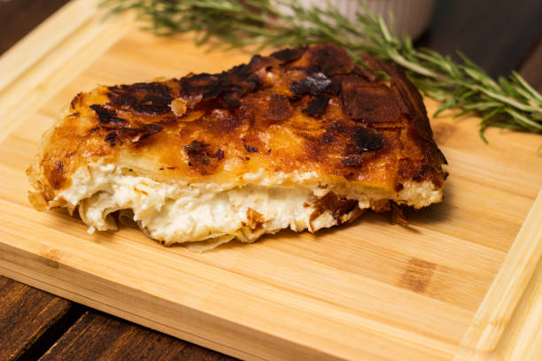 istock Homemade cheese pie, one piece on cutting board 1444208773