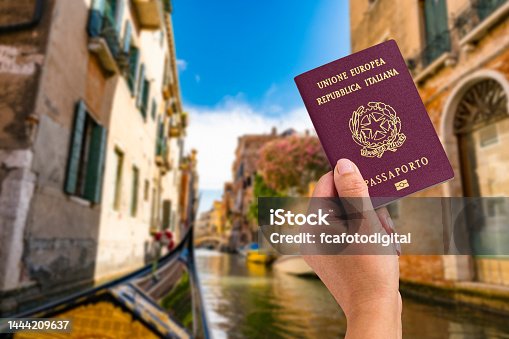 istock Woman holds Italian passport in front of Venice canal 1444209637
