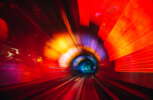 Motion blur on lines of LEDs illuminating a curving rail tunnel in Shanghai, China.