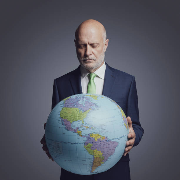 istock Corporate businessman holding a globe 1444211068