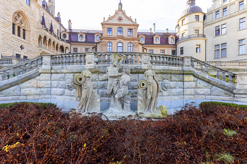 Moszna, Opole, Poland - November 12, 2022: 17th century Moszna Castle, view of human statues in front of building. Castle is one of the best known monuments in western part of Upper Silesia