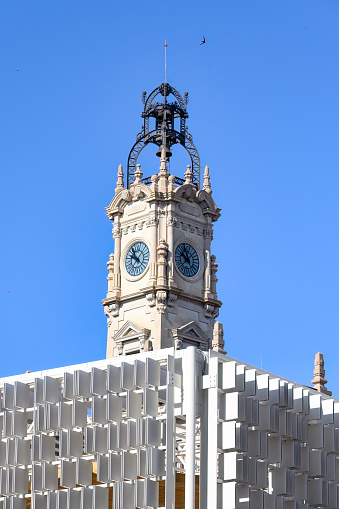 Two clocks on a bell tower of a building in Valencia, Spain