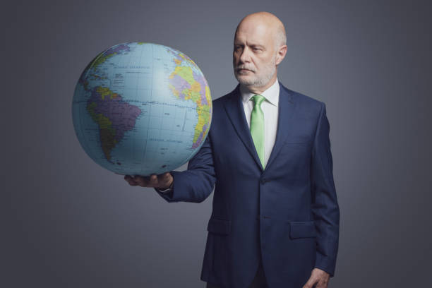 istock Corporate businessman holding a globe 1444211568