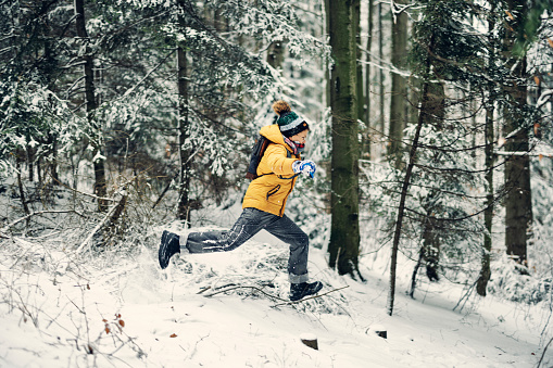 Boy running through beautiful snowy forest on a winter day
Shot with Canon R5