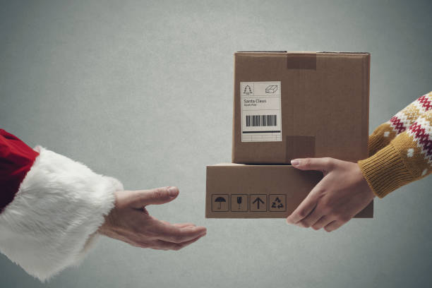 istock Santa Claus receiving boxes hands close up 1444213080