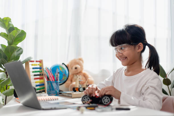 istock Asia students learn at home in coding robot cars and electronic board cables in STEM, STEAM, mathematics engineering science technology computer code in robotics for kids concept. 1444215149
