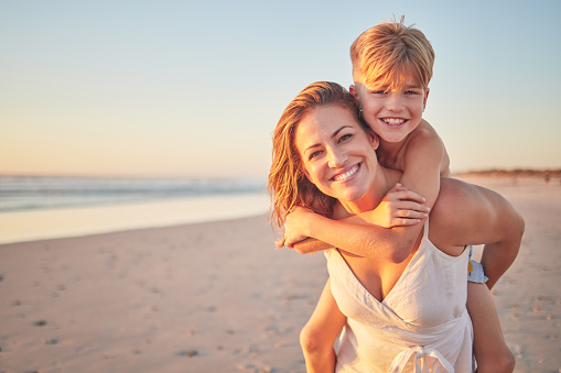 Mom, piggyback kids and portrait at beach holiday, summer vacation and ocean relax together for fun, freedom and quality time in Australia. Happy mothers day, excited boy children and sunshine sea