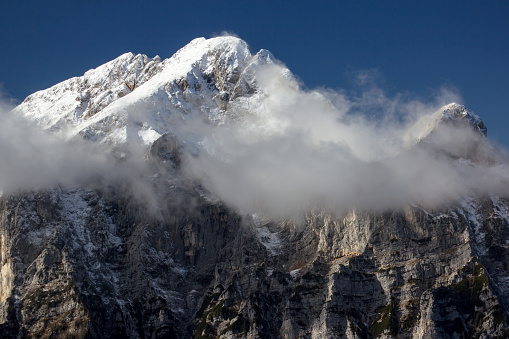 Julian Alps Slovenia, peak Debela Pec 2014 m, winter hiking in Triglav with snowy peaks and mist