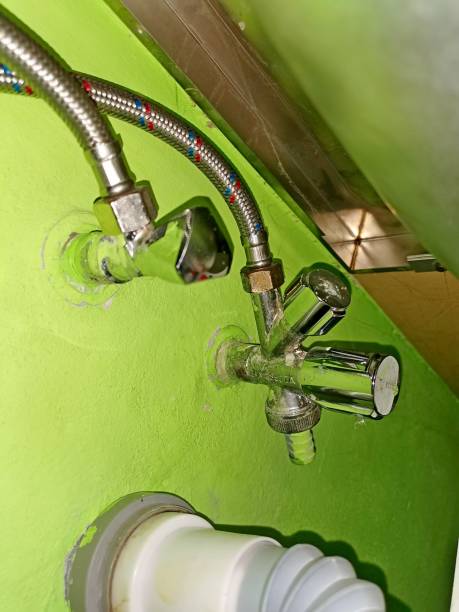 istock Plumbing valves under the kitchen counter, with hoses and waste pipe 1444219371