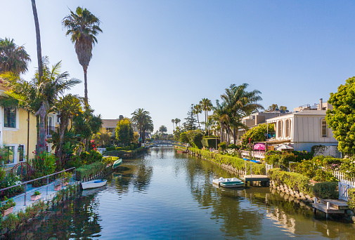 Venice, USA - July 6, 2008: old canals of Venice, build by Abbot Kinney in California, beautiful living area with boats and residential houses.