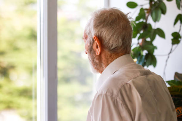 istock senior man looking out the window 1444219821