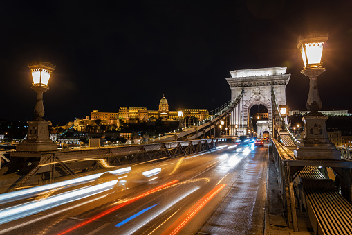 Historic landmark Szechenyi Chain Bridge over the Danube river at night in Budapest, Hungary.