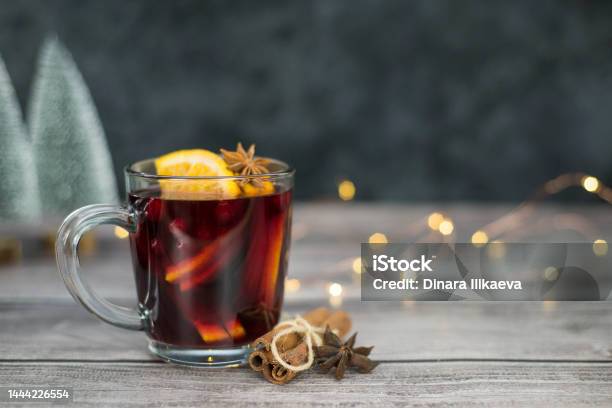 https://media.istockphoto.com/id/1444226554/photo/mulled-wine-with-orange-in-a-glass-on-dark-and-brown-with-lights-background-christmas-drink.jpg?s=612x612&w=is&k=20&c=d2aW1YVNT0q-EzKA4cOhGNJfqENDt1MTyW479V2kp7Y=