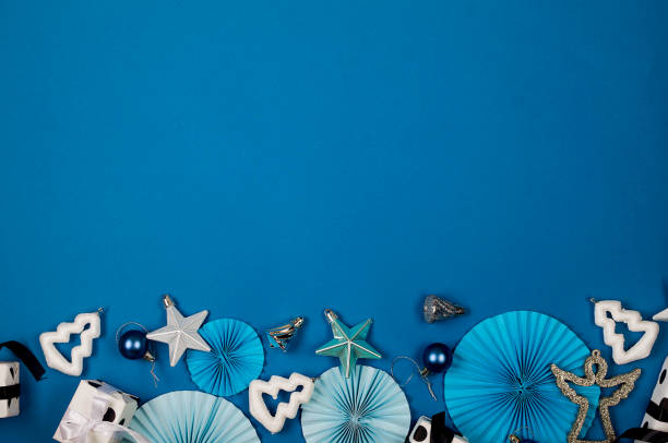 istock Christmas background with gift boxes, baubles, branches and ribbon on blue. 1444228778