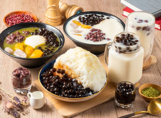 Assorted grass belly, mango, taro, soy milk, shaved ice, red beans, rice ball served in bowl isolated on table top view of asian food