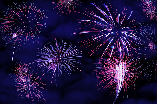 Set of fireworks on a night blue sky background.