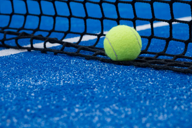istock selective focus, a ball at the net on a blue paddle tennis court 1444229877
