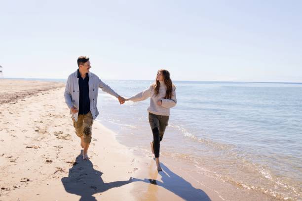 istock Happy couple running along the beach 1444230329