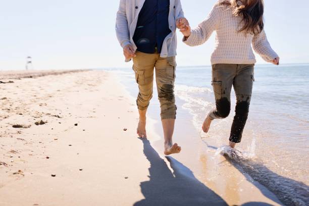 istock Unrecognisable couple running along the beach 1444230367