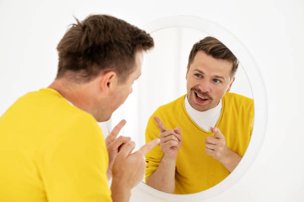 istock young man trying to cheer himself up before a first date 1444231700