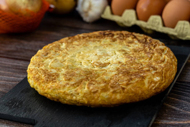 istock Spanish potato omelette  ingredients wooden background. 1444231730
