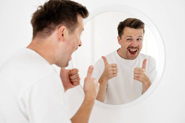istock young man trying to cheer himself up before a first date 1444232185