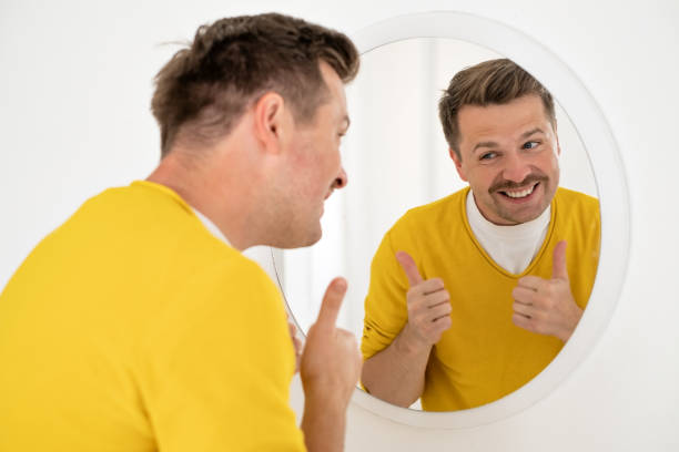 istock young man trying to cheer himself up before a first date 1444232929