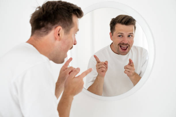 istock young man trying to cheer himself up before a first date 1444233674